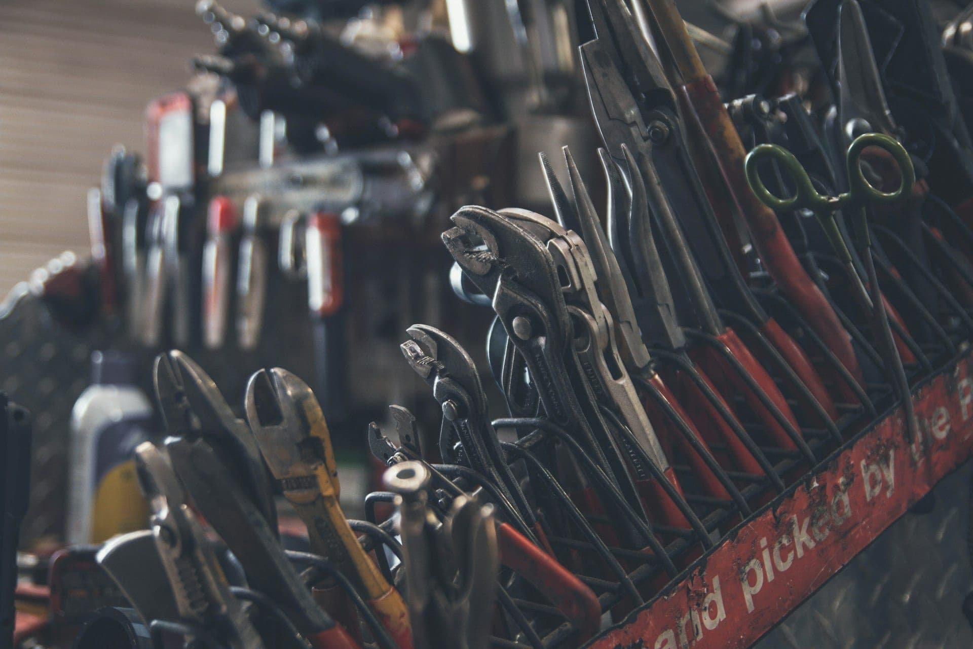 An organized set of hand tools laid out on a workbench.