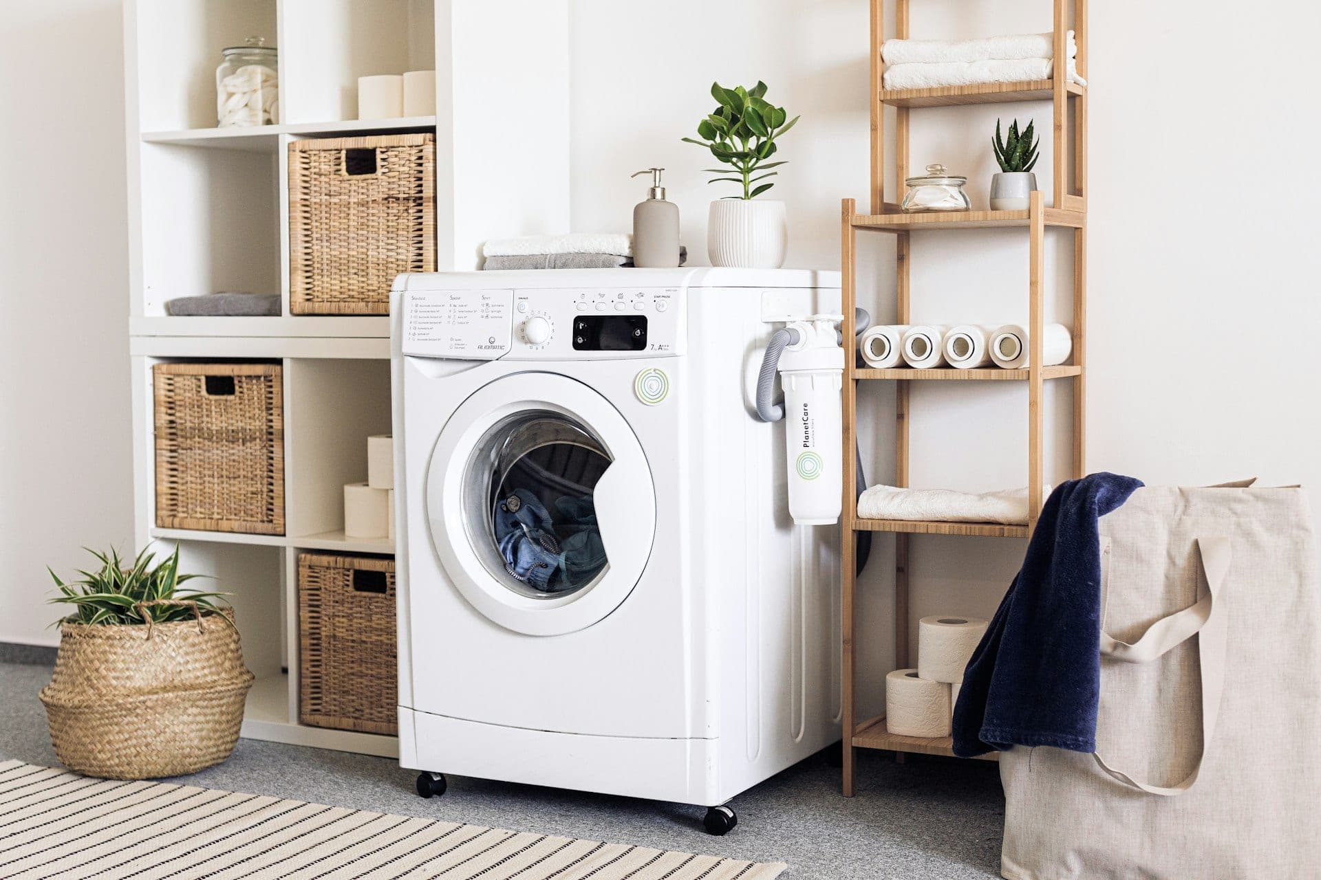 A front-loading washing machine in a tidy laundry room.